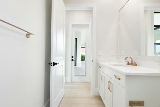 bathroom with vanity and hardwood / wood-style flooring