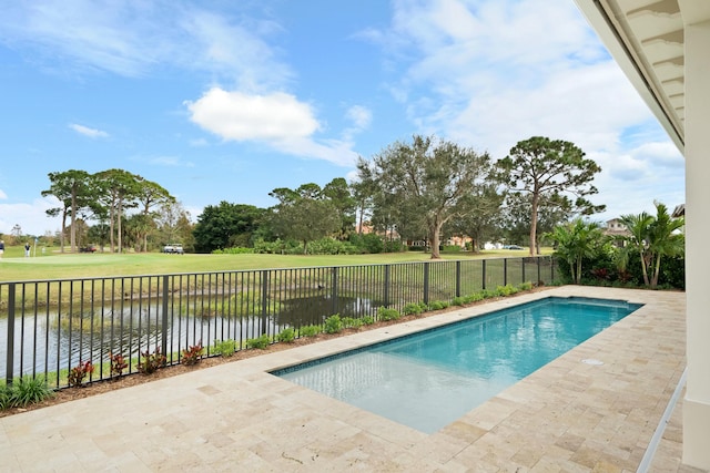 view of pool with a patio, a water view, and a yard