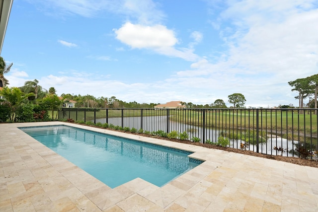 view of swimming pool featuring a water view and a patio area