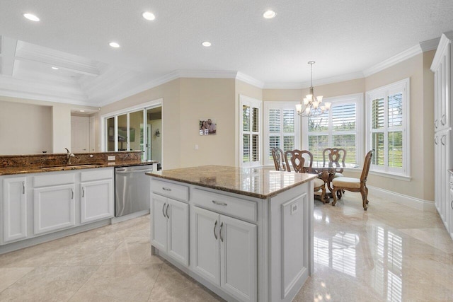 kitchen with stainless steel dishwasher, decorative light fixtures, an inviting chandelier, and crown molding