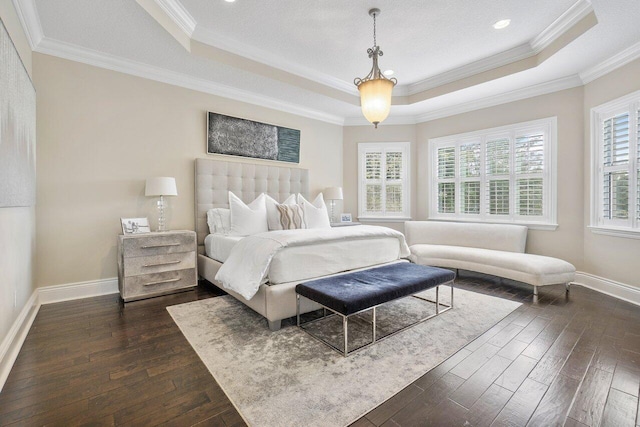 bedroom with crown molding, a raised ceiling, multiple windows, and dark hardwood / wood-style flooring