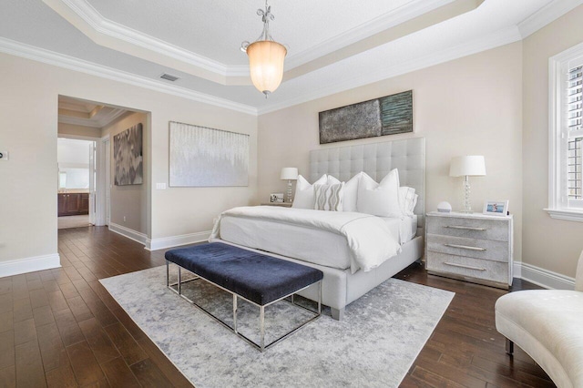 bedroom with a tray ceiling, dark hardwood / wood-style floors, and crown molding