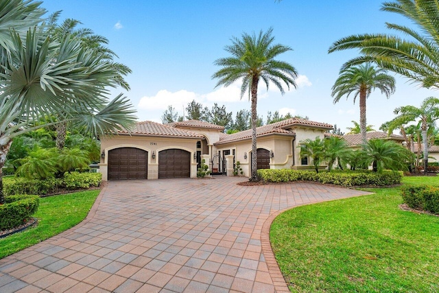 mediterranean / spanish house with a front yard and a garage