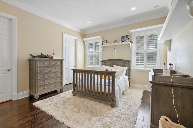 bedroom featuring crown molding, dark hardwood / wood-style floors, and a textured ceiling