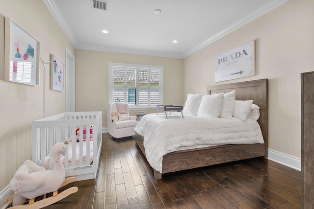 bedroom with crown molding and dark hardwood / wood-style floors