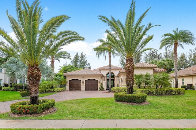 mediterranean / spanish house with a front yard, a garage, and central air condition unit