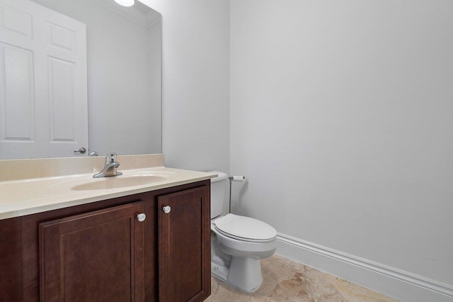 bathroom featuring toilet, tile flooring, and vanity