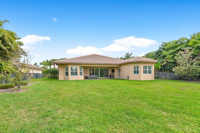 rear view of house featuring a lawn