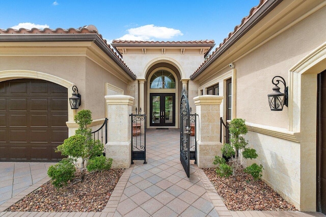 doorway to property with french doors and a garage