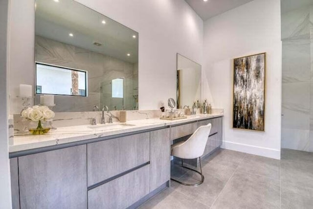 bathroom featuring tiled shower, vanity, and tile patterned floors