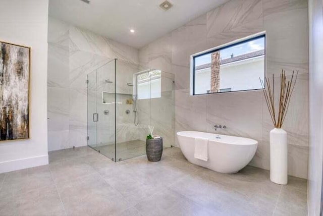 bathroom with tile walls and plus walk in shower