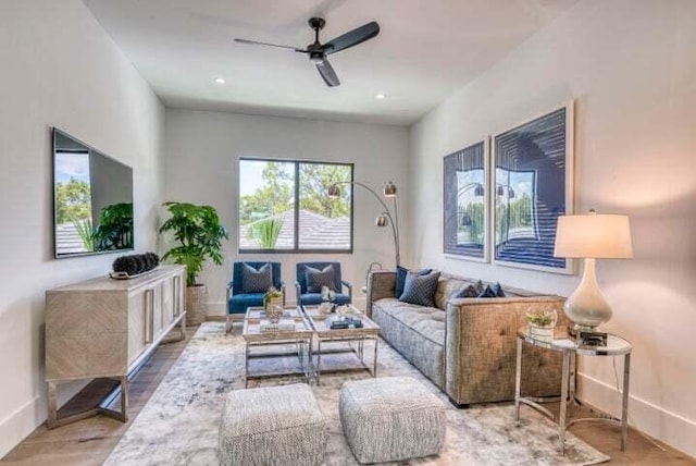 living room featuring ceiling fan and hardwood / wood-style flooring