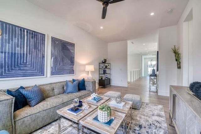 living room featuring light hardwood / wood-style floors and ceiling fan