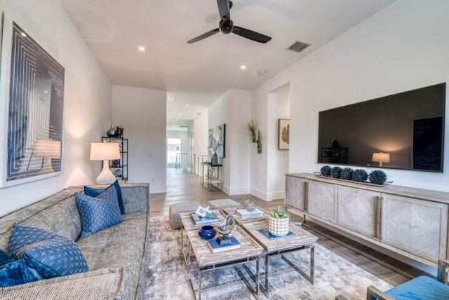 living room with ceiling fan and hardwood / wood-style flooring