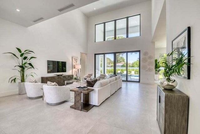 living room featuring a towering ceiling