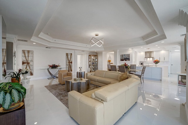 living room featuring crown molding and a raised ceiling