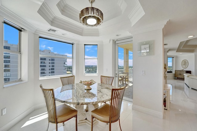 dining room with ornamental molding, a raised ceiling, and light tile patterned floors