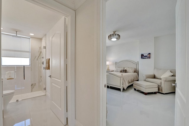 bedroom with light tile patterned flooring and ensuite bath