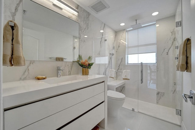 bathroom featuring vanity, toilet, tile patterned floors, and a shower with shower door