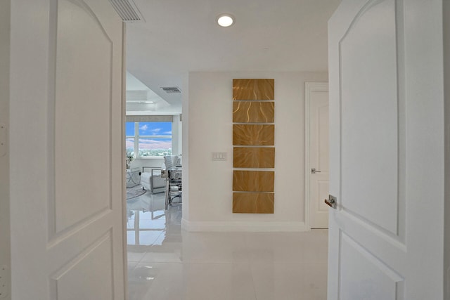 hall with light tile patterned floors