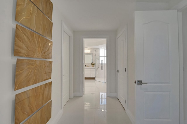 hall with light tile patterned floors