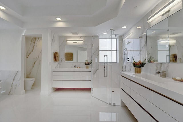 bathroom with vanity, toilet, tile patterned floors, and a shower with door