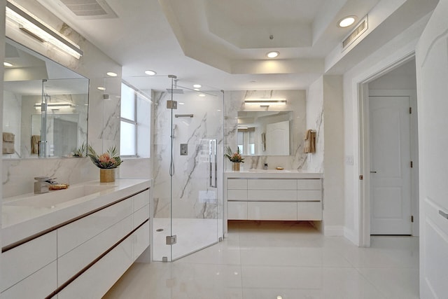 bathroom with vanity, tile patterned flooring, a raised ceiling, and a shower with door