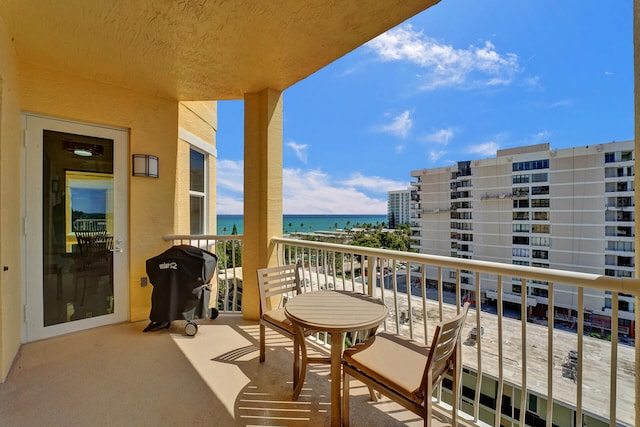 balcony featuring grilling area and a water view