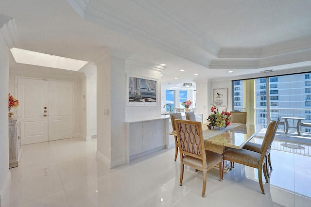 dining space with ornamental molding and light tile patterned floors