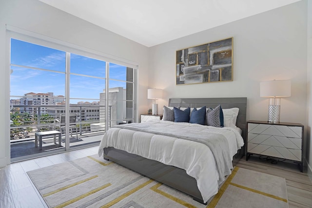 bedroom with light hardwood / wood-style floors and access to exterior