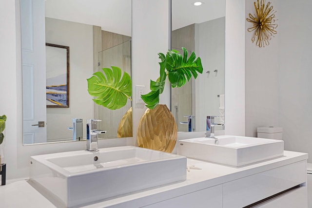 bathroom featuring walk in shower, vanity, and toilet