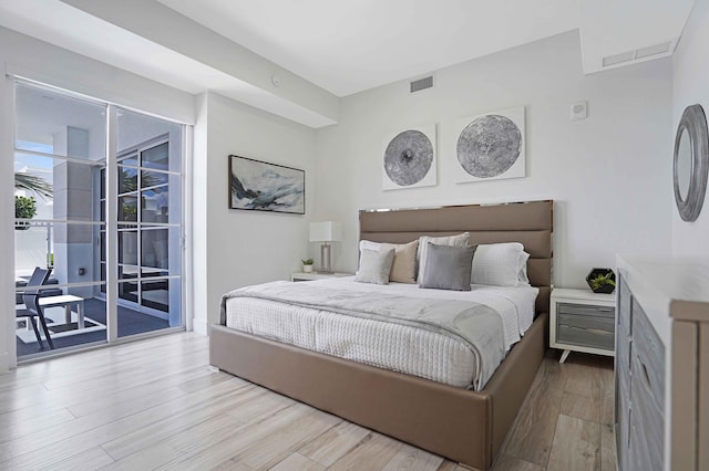 bedroom featuring light wood-type flooring and access to exterior