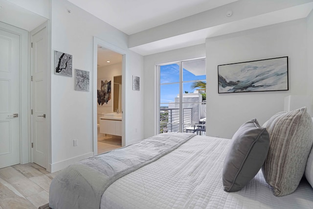 bedroom featuring access to outside, ensuite bathroom, and light wood-type flooring