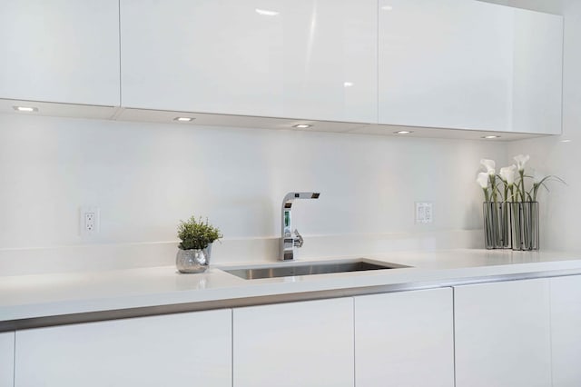 kitchen featuring white cabinets and sink