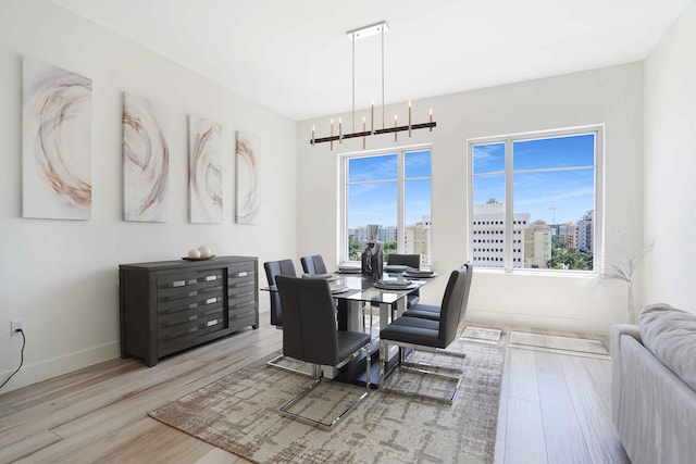 dining space featuring a chandelier and light hardwood / wood-style flooring