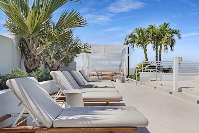 view of patio with an outdoor living space and a water view