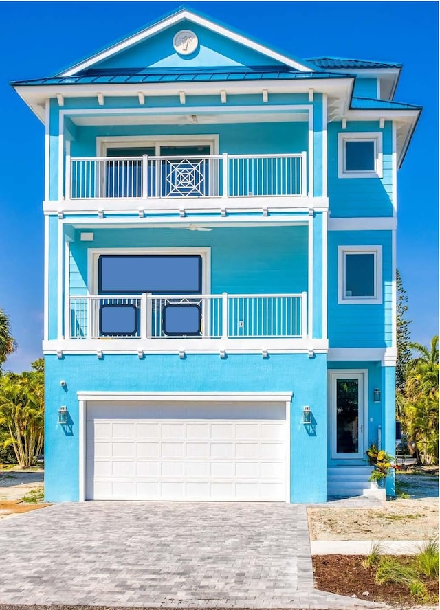 view of front facade with a balcony and a garage