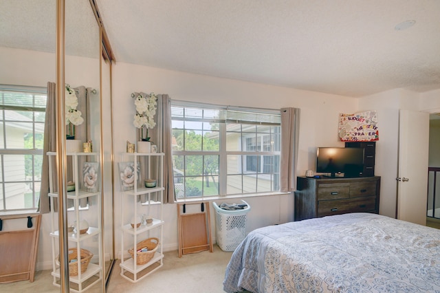 carpeted bedroom featuring a textured ceiling