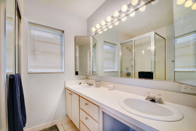 bathroom with double sink, tile floors, and vanity with extensive cabinet space