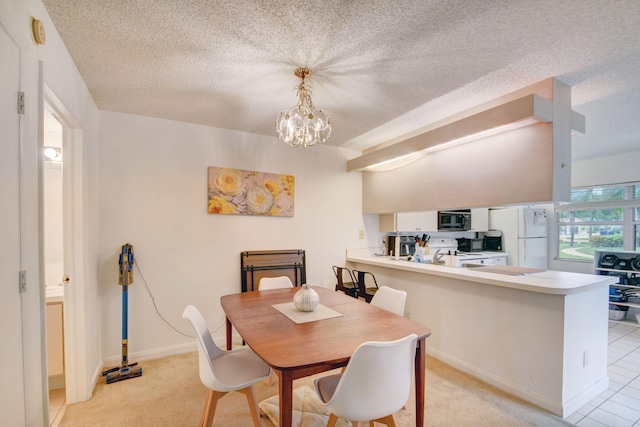 carpeted dining room with a notable chandelier and a textured ceiling