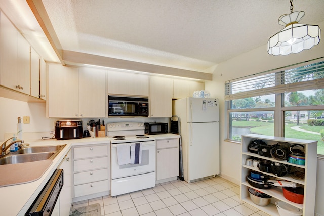 kitchen featuring white appliances, sink, a textured ceiling, and light tile floors