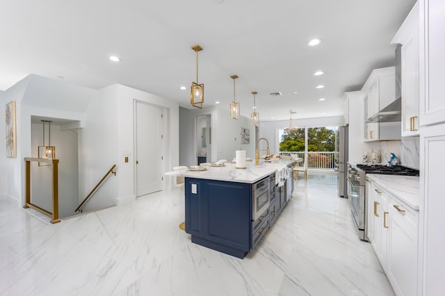 kitchen with white cabinetry, stainless steel appliances, an island with sink, blue cabinetry, and light tile patterned floors