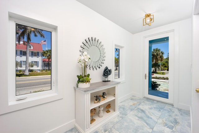 doorway to outside with light tile patterned flooring