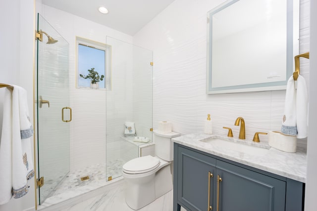 bathroom with tile walls, toilet, and vanity