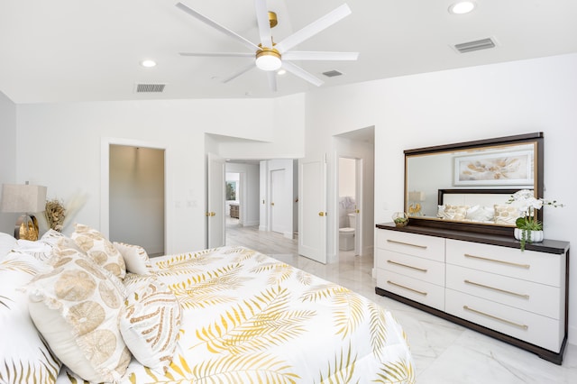 tiled bedroom featuring ensuite bath, ceiling fan, and vaulted ceiling