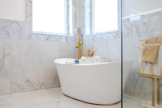 bathroom featuring tile patterned flooring and tile walls