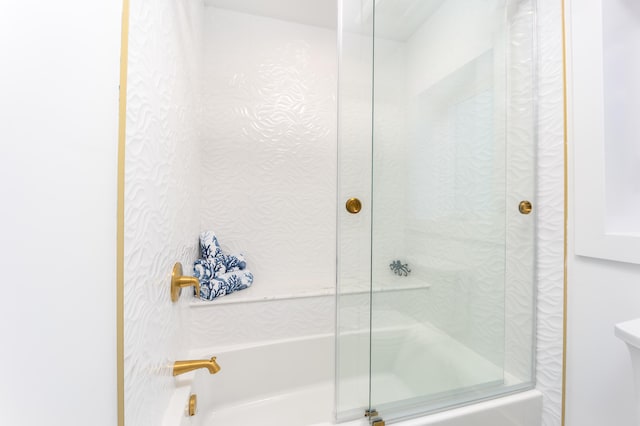 bathroom featuring bath / shower combo with glass door