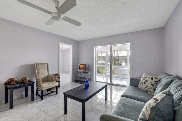 sitting room with light tile floors, a textured ceiling, and ceiling fan