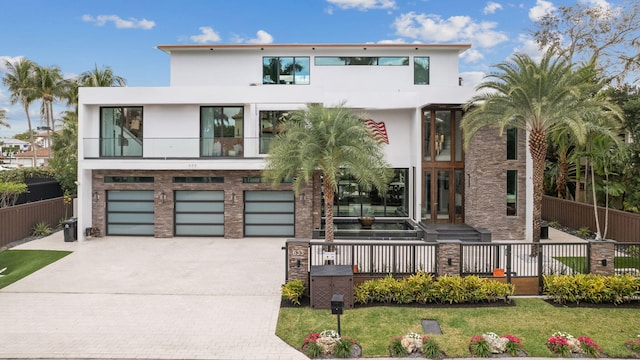 contemporary house featuring a front lawn and a garage