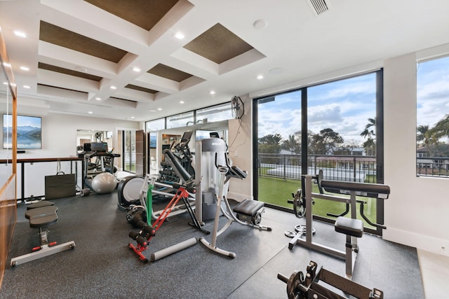 workout area featuring coffered ceiling, floor to ceiling windows, and a healthy amount of sunlight